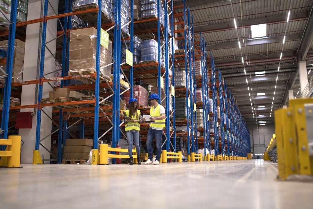 Warehouse managers evaluating a storage facility for a mezzanine floor installation