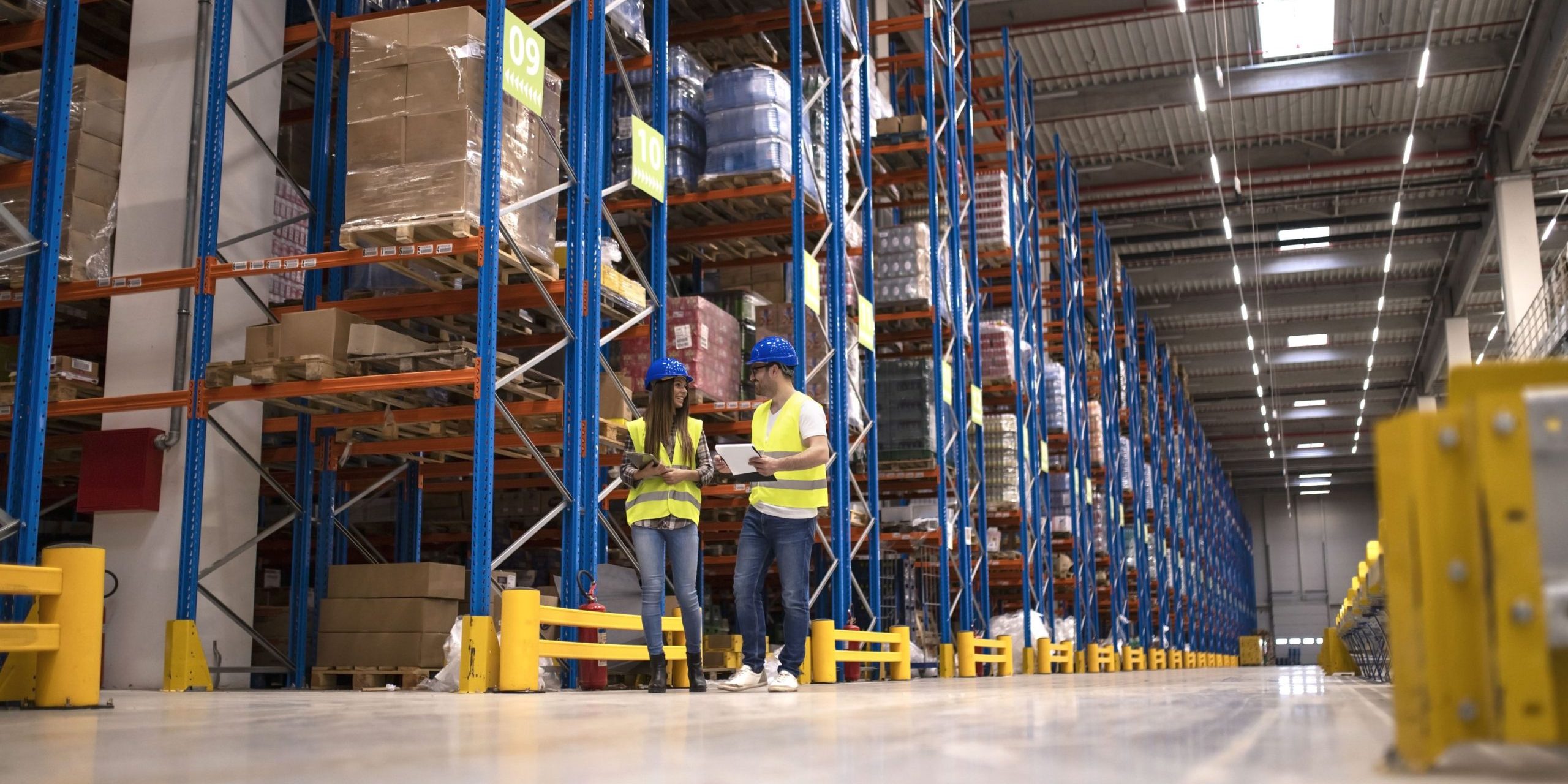 industrial flooring (1) Warehouse managers evaluating a storage facility for a mezzanine floor installation
