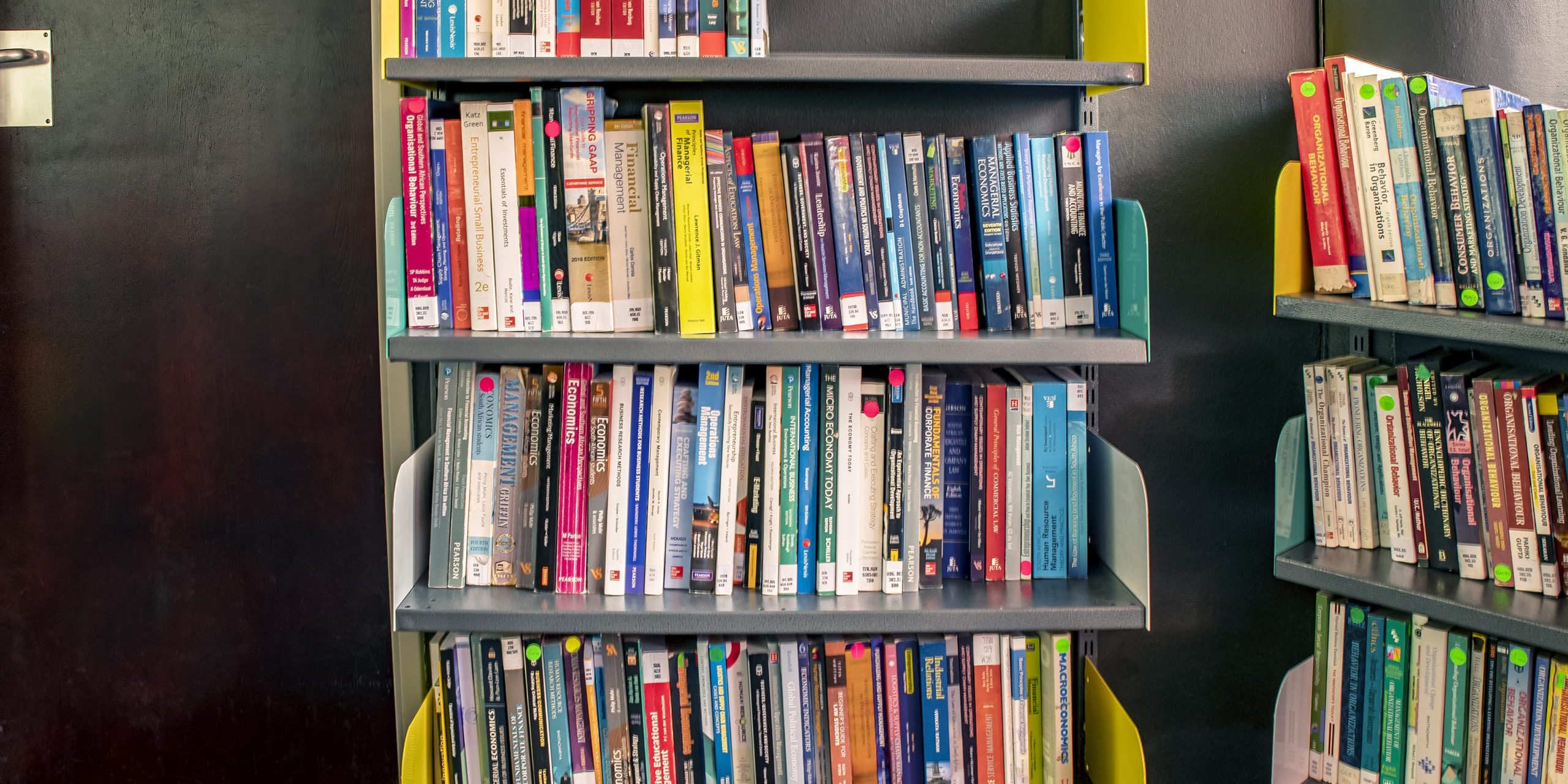 A Row of Krost Shelving & Racking's Library Shelve with aCollection of books.