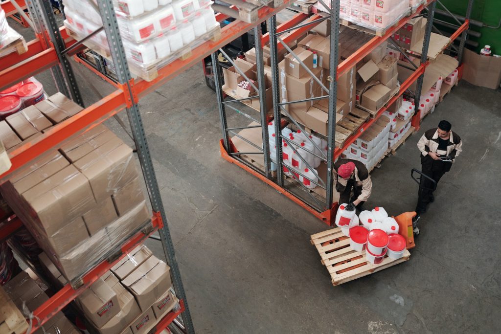 Men unpacking stock from warehouse racking on to pallets