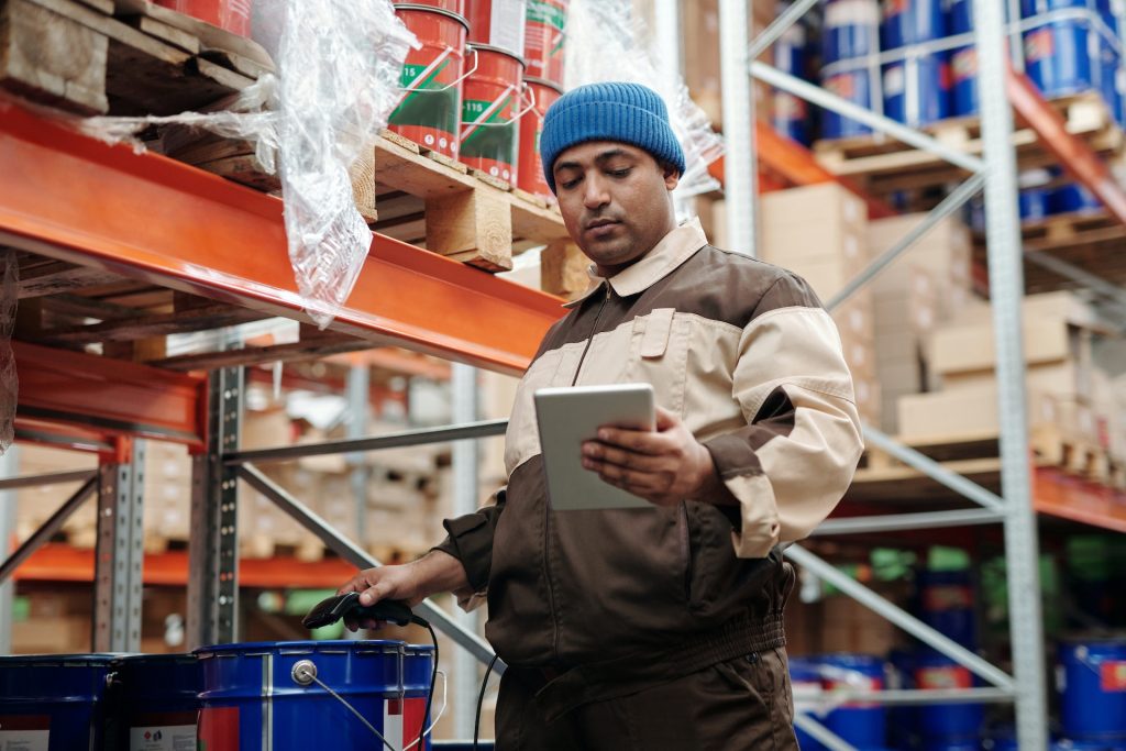Man checking stock in front of warehouse racking installation