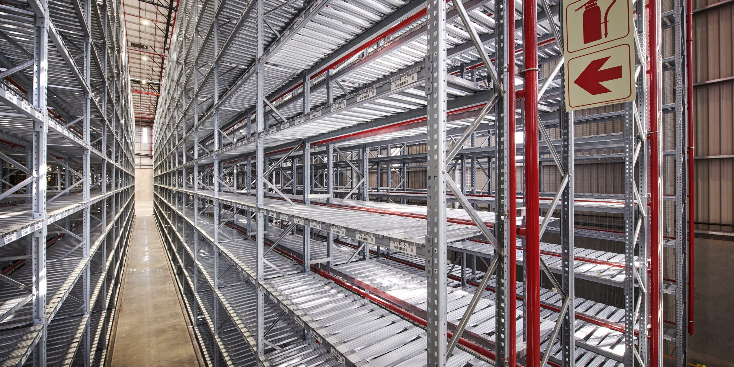 _DSC9016 Row of heavy duty metal shelves in a warehouse with warning signs