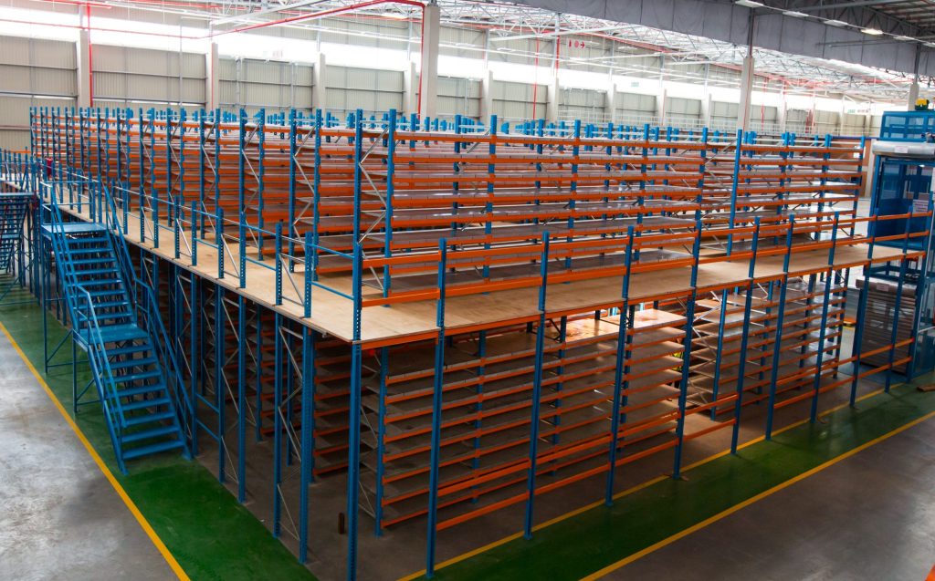 Rack supported mezzanine floor system installed in a warehouse