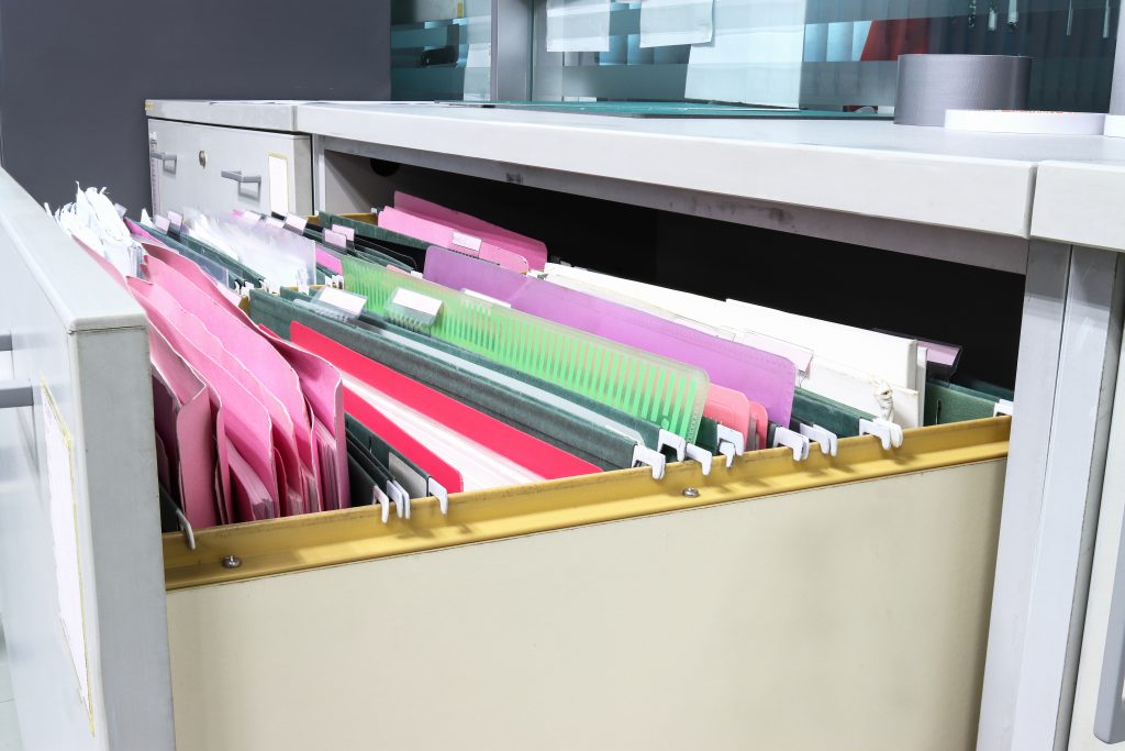 Documents and folders in a filing cabinet.