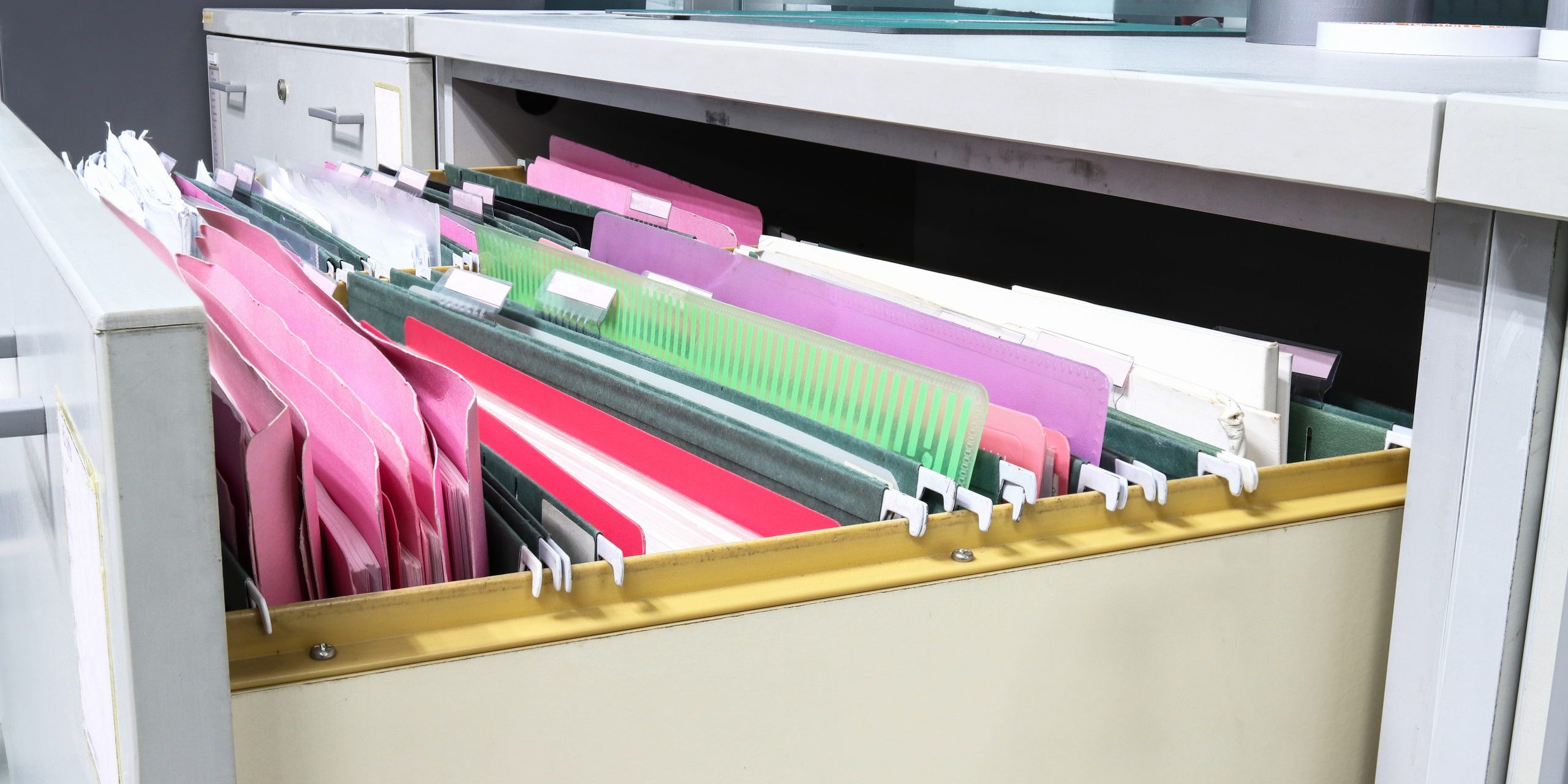 Documents and folders in a filing cabinet.