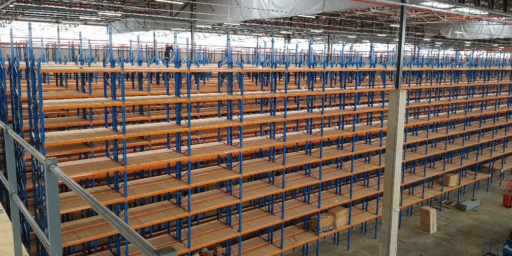 Installation process of rivet shelving in a warehouse.