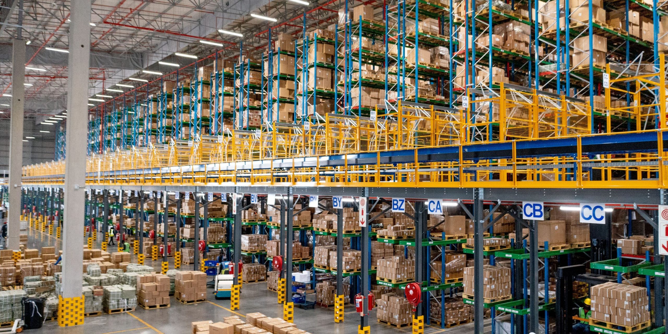 DJI_0068 Large warehouse fitted with a stacked blue and yellow VNA racking system to highlight the influences of VNA racking prices