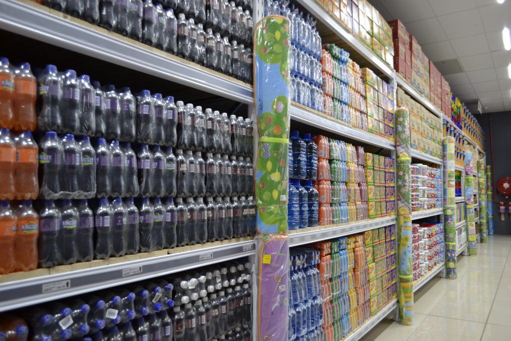 Selective racking system packed with goods in a retail store.