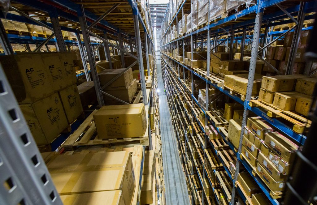 A very narrow aisle system packed with boxes in warehouse