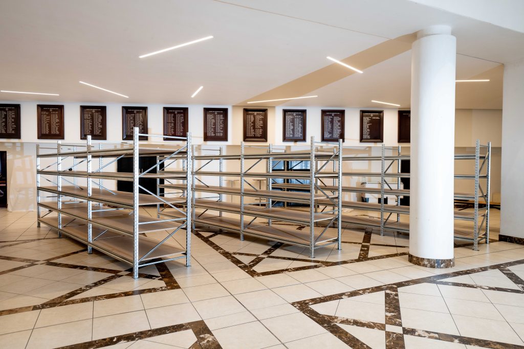 3 empty long span racking structures in a fancy lobby serving as light-duty racking systems