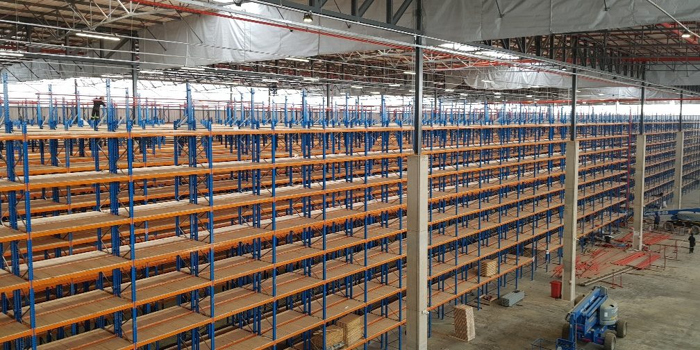 20191119_095518_resized_1 Workers installing a high multi-level warehouse shelving in a large distribution centre