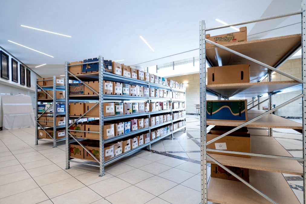 Steel racking inside a tiled store room to make best use of stock organisation