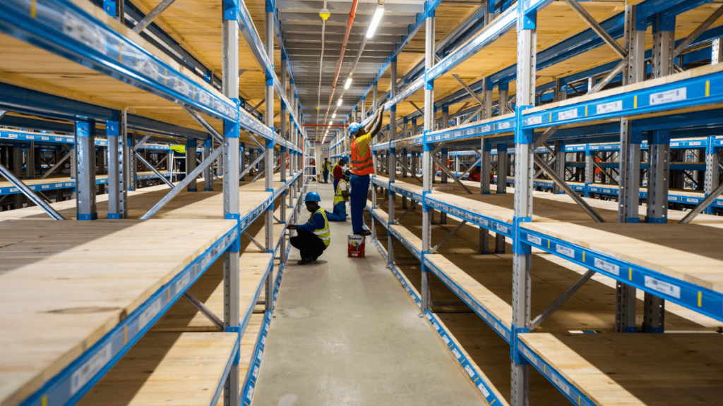 Warehouse workers in an aisle of a catwalk racking system