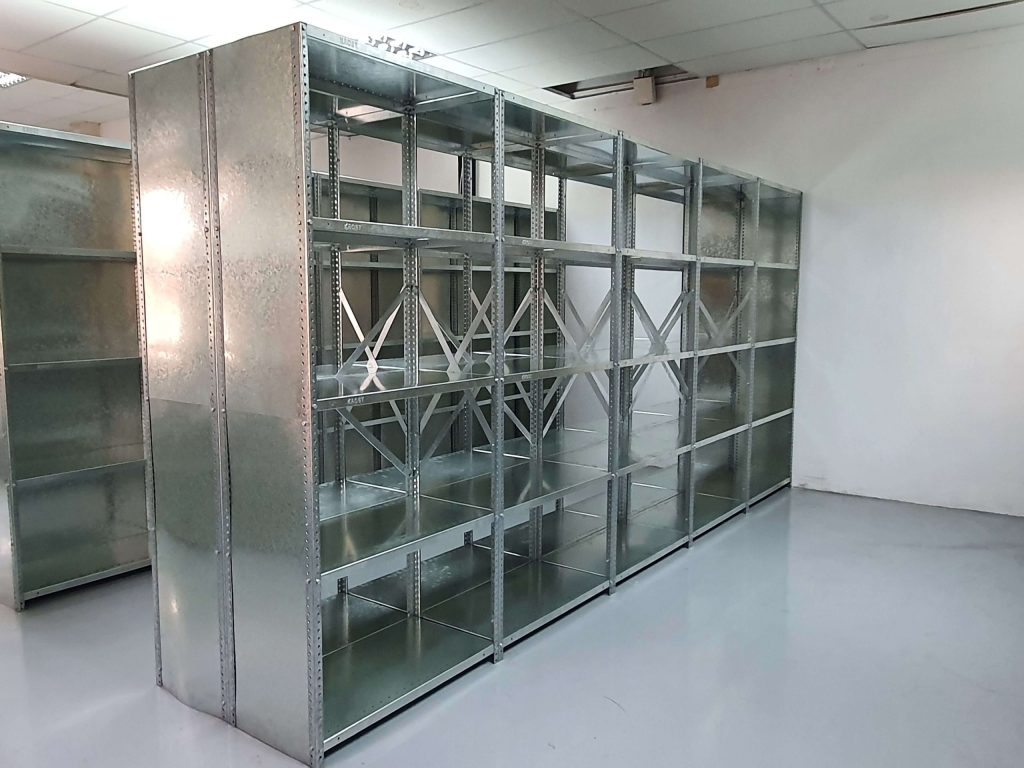 Bolted shelving vs. carton live racking: standalone bolted shelves in an empty storage facility