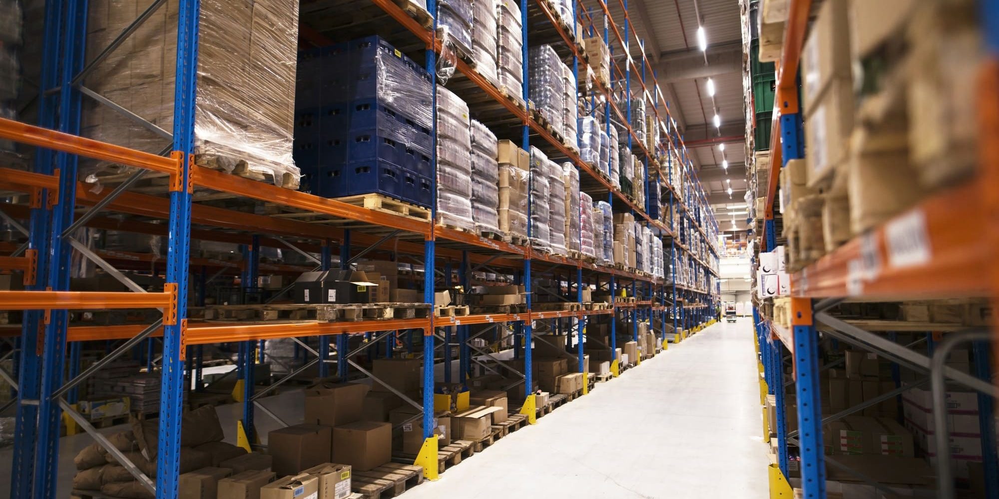 interior-large-distribution-warehouse-with-shelves-stacked-with-palettes-goods-ready-market (1) The best industrial shelving South Africa in a fully stocked distribution centre