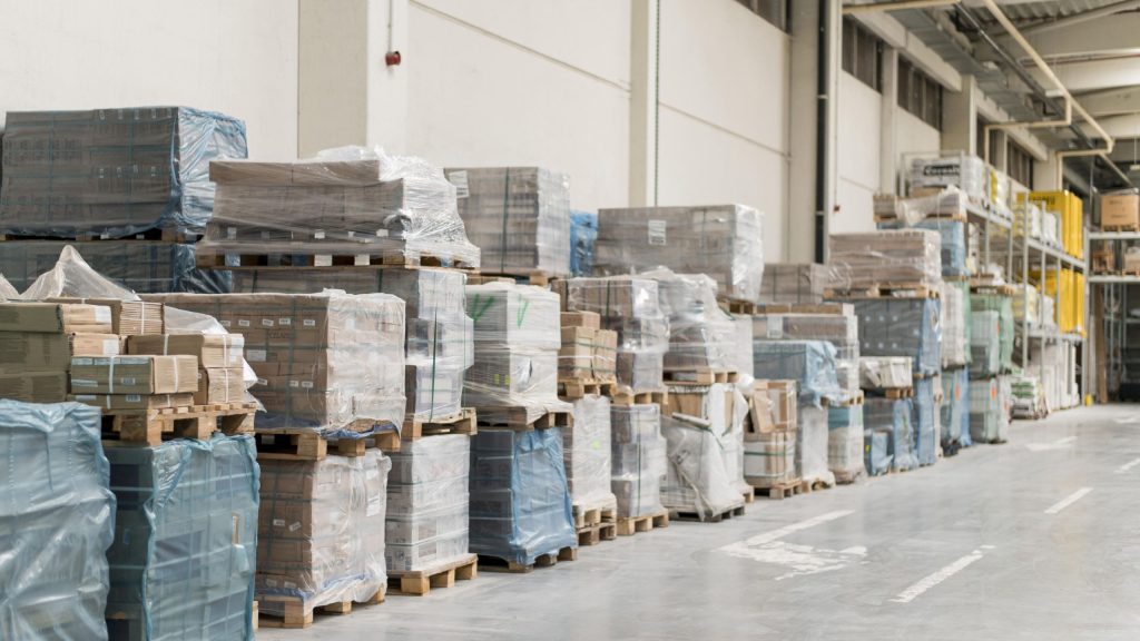 Block stacking vs. warehouse shelving: A warehouse with boxes arranged uses block stacking