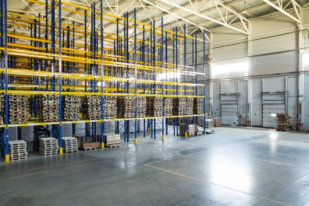 Selective storage racking vs. gondola shelving: A multi-level selective storage rack stacked with empty pallets
