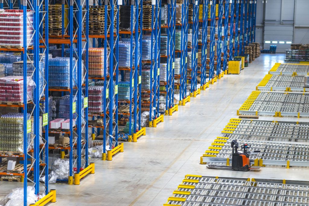 Merchandise packages on drive-in storage racking with courier stamps and receipts in warehouse