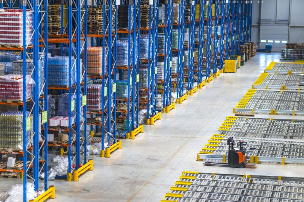 Merchandise packages on drive-in storage racking with courier stamps and receipts in warehouse