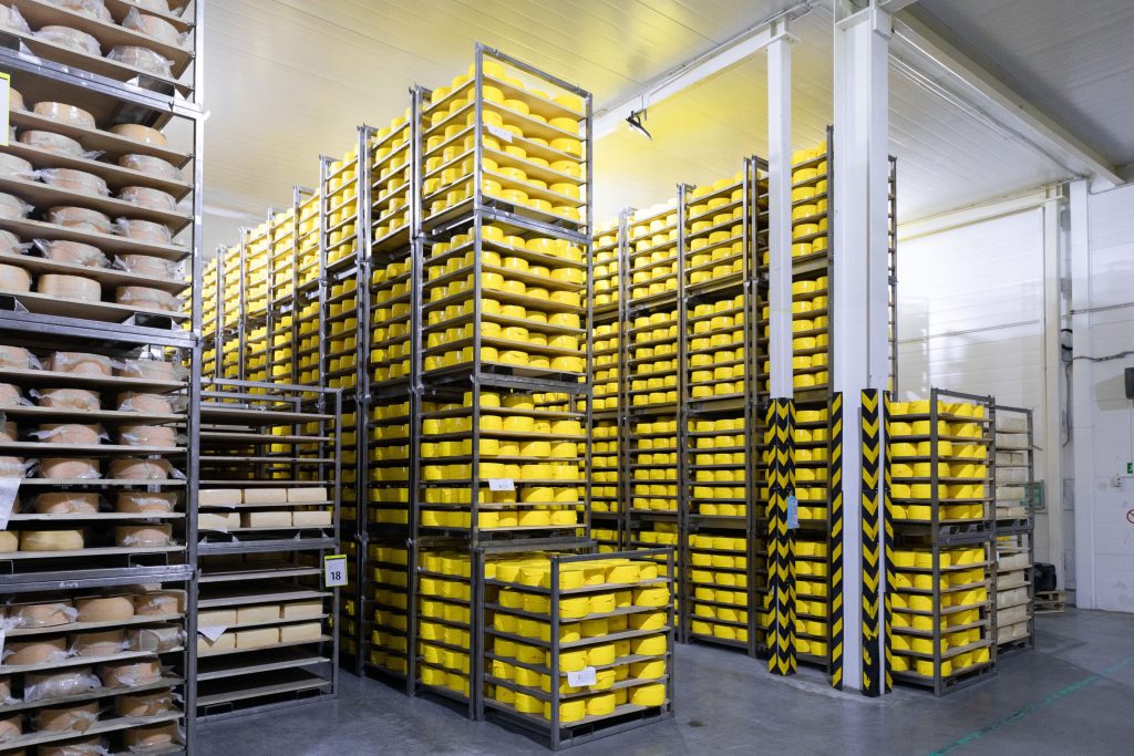 Cheese stored in a large cold room in a commercial kitchen bought using industrial shelving prices
