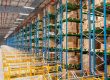 A large, densely stacked VNA rack in a warehouse showing how rivet shelving and VNA racking compare.