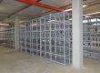 A brand new bolted shelving unit in an empty warehouse.