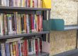Installed library shelves stocked with books to compare cantilever racking vs. library shelving