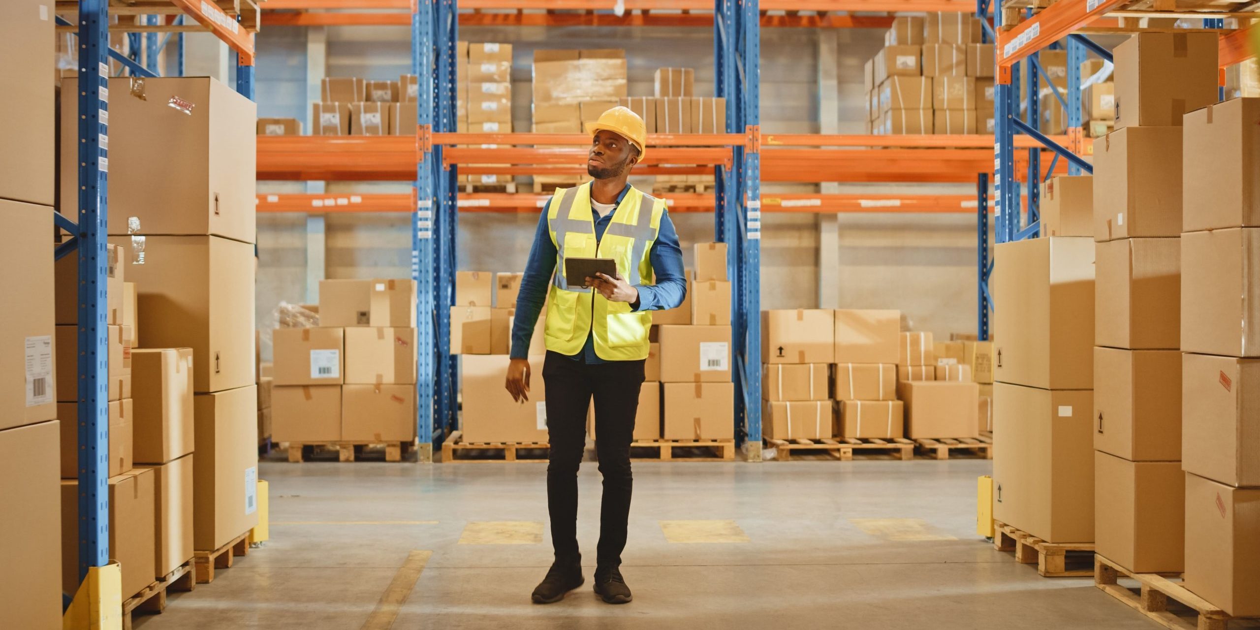A warehouse worker inspecting goods stored using flexible storage solutions