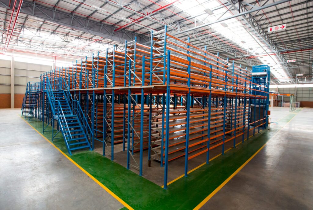 Rack supported mezzanine floor with blue staircases by Krost